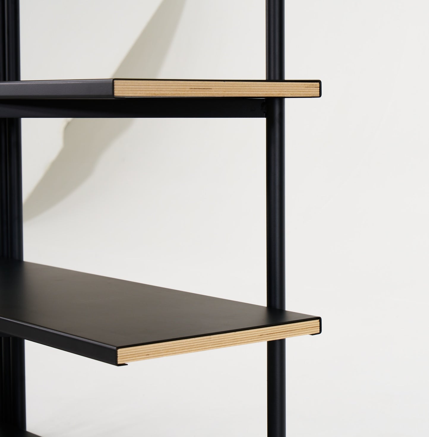FLO Media Modular Shelving – black frame, end view showing wood and metal shelf interaction