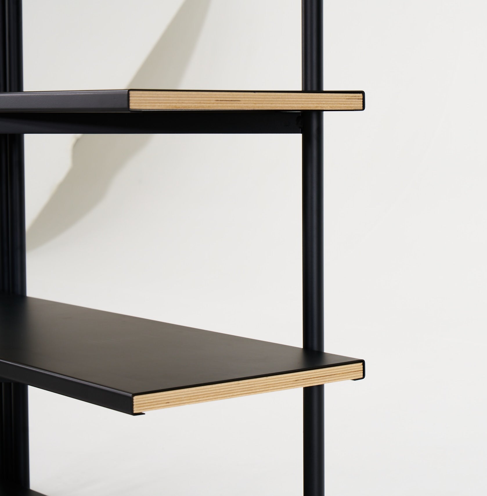 FLO Media Modular Shelving – black frame, end view showing wood and metal shelf interaction