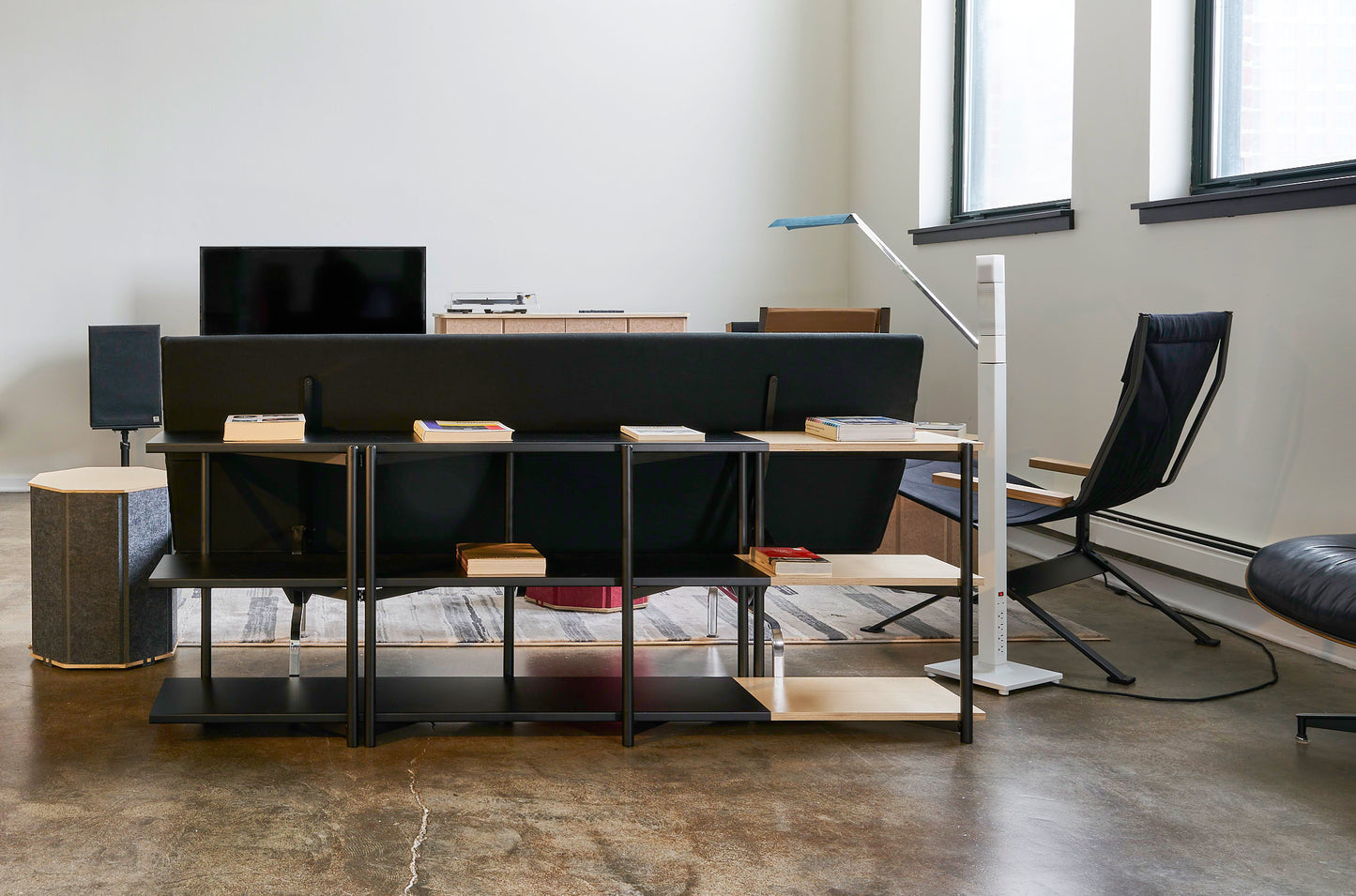 FLO Media Modular Shelving – lifestyle front view, black frame behind couch 