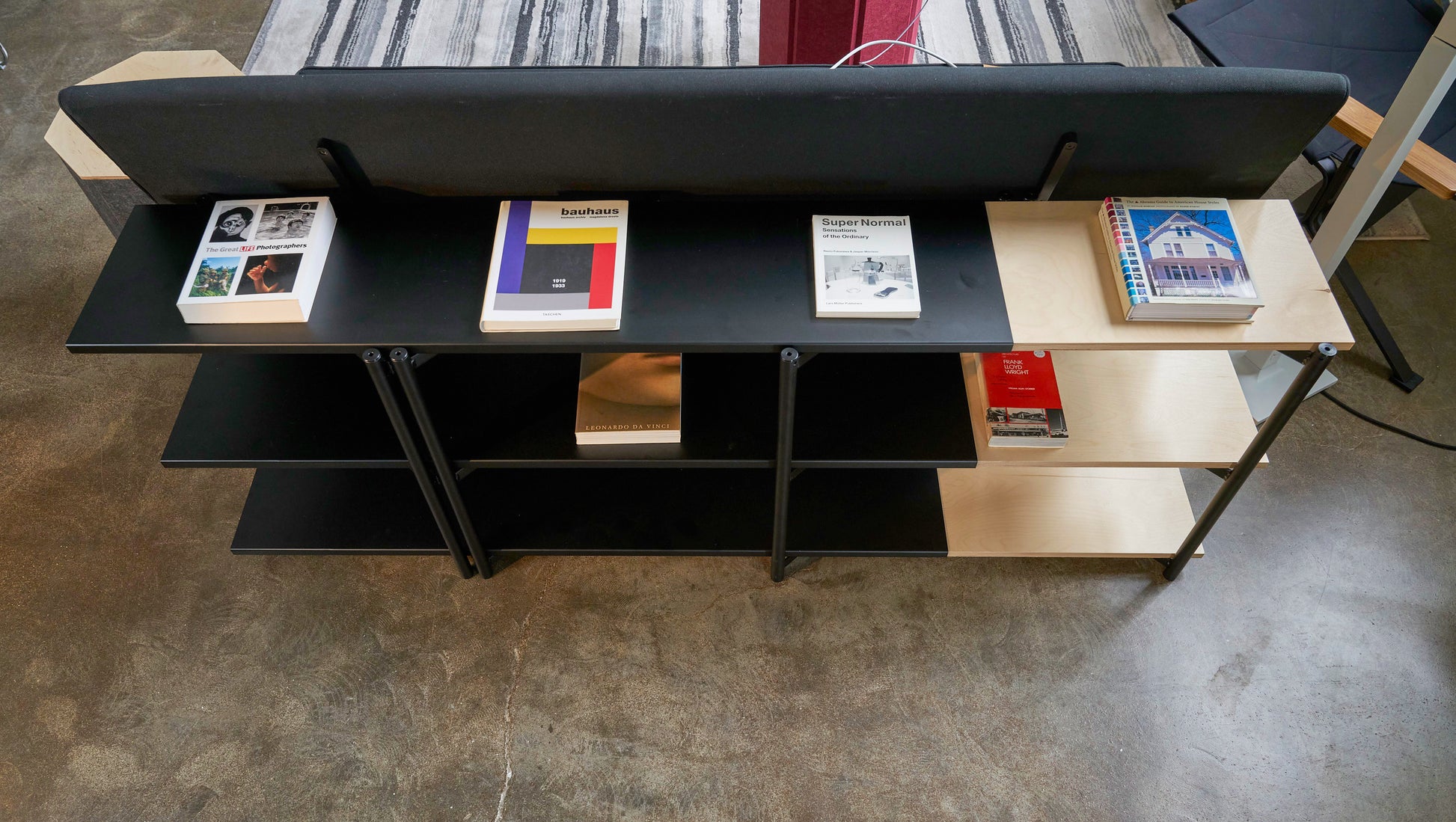 FLO Media Modular Shelving – lifestyle top view, black frame behind couch
